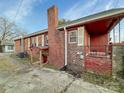 Brick home exterior showcasing a cozy porch, brick chimney, and potential outdoor living space at 630 N Moran St, Gastonia, NC 28052