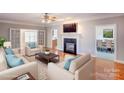 Bright living room with hardwood floors, fireplace, and comfortable seating, great for relaxation and entertaining guests at 8622 Lower Rocky River Rd, Concord, NC 28025