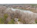 An aerial view of a home, showcasing proximity to a large lake at 9230 Windygap Rd, Charlotte, NC 28278