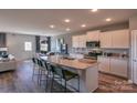 Modern kitchen with white cabinets, granite countertops, and an island at 12028 Grinstead Ln # 292, Charlotte, NC 28278