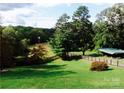 Landscaped yard with a windmill, providing a picturesque rural setting at 1262 Ring Tail Rd, Claremont, NC 28610