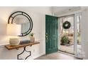 Bright entryway with wood floors, a decorative mirror, and a view of the front yard at 17521 Cambridge Grove Dr, Huntersville, NC 28078