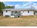 Back exterior of home featuring a small deck and yard with grass at 1876 Rollins Dr, Catawba, NC 28609