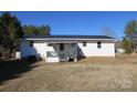 Rear view of the house showing a back porch and yard at 1876 Rollins Dr, Catawba, NC 28609