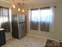 Modern kitchen features stainless steel appliances and marble-look floors at 1876 Rollins Dr, Catawba, NC 28609