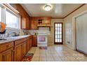 Charming kitchen with wooden cabinets, a white oven, and a window above the sink for natural light at 1900 E Dixon Blvd, Shelby, NC 28152