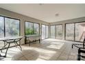 Bright sunroom featuring tile floors, multiple sliding glass doors, and ample natural light at 1900 E Dixon Blvd, Shelby, NC 28152