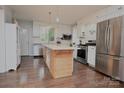 Modern kitchen with white cabinets, stainless steel appliances, and large island at 198 Clouse Ln, Taylorsville, NC 28681