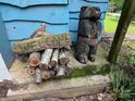 Rustic welcome sign with carved bear and firewood for a charming, inviting entrance at 198 Clouse Ln, Taylorsville, NC 28681