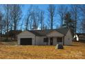 Modern farmhouse exterior with a black roof and attached garage at 2045 Cordia Cir, Newton, NC 28658