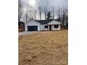 Newly constructed home with a white exterior, black garage door, and a covered porch at 2045 Cordia Cir, Newton, NC 28658