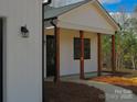 Inviting front porch with wood columns and black trim at 2045 Cordia Cir, Newton, NC 28658