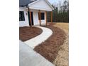 Landscaped front yard with a curved walkway leading to the front porch at 2045 Cordia Cir, Newton, NC 28658