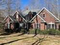 Two-story brick home with a landscaped yard and mature trees at 2113 Sweet Clover Way, Denver, NC 28037