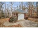 Detached brick garage with a white door and a landscaped area at 2113 Sweet Clover Way, Denver, NC 28037