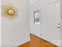 Bright entryway with hardwood floors and a sunburst mirror at 3019 Parkstone Dr, Charlotte, NC 28210