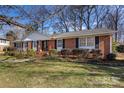 Ranch style brick home with a landscaped yard at 3019 Parkstone Dr, Charlotte, NC 28210