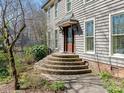 Elegant front entrance featuring brick steps, a covered porch and sidelight windows at 3041 Valencia Ter, Charlotte, NC 28211