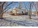 Side view of charming craftsman home with snowy yard at 400 E 27Th St, Kannapolis, NC 28083