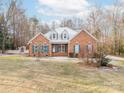 Ranch style brick home with a landscaped yard at 4025 Weddington Manor Ct, Matthews, NC 28104