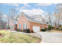 Brick home with a two-car garage and manicured lawn at 4025 Weddington Manor Ct, Matthews, NC 28104