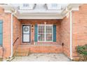 Front entrance with brick columns and teal shutters at 4025 Weddington Manor Ct, Matthews, NC 28104