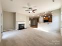 Open living room with fireplace and kitchen views at 5052 Haven Lodge Rd, Matthews, NC 28104