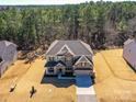 Overhead view of a traditional home boasting a manicured lawn and an attached two-car garage at 5057 Spratt Rd, York, SC 29745