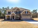 Beautiful two-story home featuring a stone and siding exterior with a two-car garage at 5057 Spratt Rd, York, SC 29745