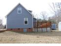 Exterior view of a house with a wooden deck, blue siding, brick foundation, and a shed in the yard at 517 Grassy Creek Run, Chester, SC 29706