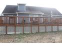 Spacious wooden deck with railings, perfect for outdoor gatherings and relaxation, overlooks a well-maintained yard at 517 Grassy Creek Run, Chester, SC 29706