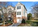 Brick townhome with 2-car garage, and a nicely landscaped yard at 804 Skybrook Falls Dr, Huntersville, NC 28078