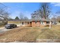 Inviting single story home with ramp access, attached garage, and manicured front yard at 901 Maple Ave, Salisbury, NC 28144