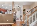 Bright and spacious entryway with staircase, hardwood floors, and view to kitchen at 10122 Oxford Landing Ln, Charlotte, NC 28270