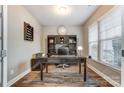 Bright home office with built-in shelving and hardwood floors at 1026 Slew O Gold Ln, Indian Trail, NC 28079