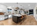 Modern kitchen featuring a large island, stainless steel appliances, and hardwood floors at 12217 Pine Valley Club Dr, Charlotte, NC 28277