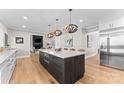 Modern kitchen with stainless steel appliances and a large island at 12217 Pine Valley Club Dr, Charlotte, NC 28277