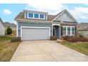 Two-story house with gray siding, stone accents, and a two-car garage at 131 E Northstone Rd, Mooresville, NC 28115