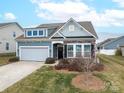 Curb appeal of a charming two-story home with gray siding and stone accents at 131 E Northstone Rd, Mooresville, NC 28115