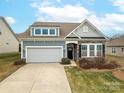 Two-story house with gray siding, stone accents, and a two-car garage at 131 E Northstone Rd, Mooresville, NC 28115