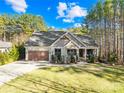 House exterior with a large yard and wooded backdrop at 137 Deer Run Dr, Troutman, NC 28166