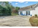 Outdoor patio area featuring a concrete patio, seating, and manicured landscaping at 160 Pampas Ln, Mooresville, NC 28117