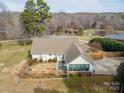 A view of the rear of the home showing a fenced-in area and manicured landscaping at 160 Pampas Ln, Mooresville, NC 28117