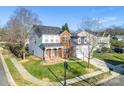 Two-story house with a gray roof and brick exterior, in a neighborhood setting at 2003 Galty Ln, Charlotte, NC 28270