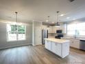 Bright modern kitchen featuring a central island, stainless appliances at 266 Gilead Rd, Huntersville, NC 28078