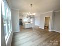 A well-lit living room seamlessly blends into a modern kitchen area at 266 Gilead Rd, Huntersville, NC 28078