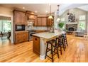 Open kitchen boasts granite island, hardwood floors, and views into the living room at 3196 Stonemill Path, Sherrills Ford, NC 28673