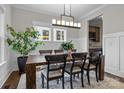 Elegant dining room featuring a large wooden table and built-in wine storage at 423 Solomon St, Charlotte, NC 28216