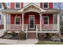 Charming front porch with white railings and American flag at 423 Solomon St, Charlotte, NC 28216