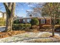 Brick Ranch home with snowy front yard and large tree at 4419 Halstead Dr, Charlotte, NC 28209